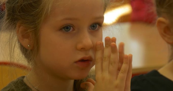 Timid Girl Prays Near Other Children