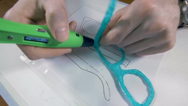 Man assembling glasses made with 3D pen. Innovative production technology. 4K.