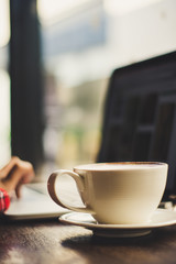 working and coffee cup on the wood table