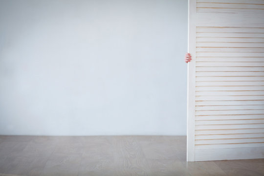 Baby Hand Holding The Door Open. Clean Background