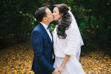 Wedding photo shoot. Beautiful groom and bride in nature.