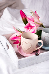 tray with cup of hot tea in the bed,