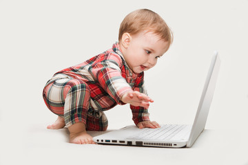 Baby with laptop on the white background