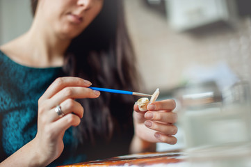 girl in a blue dress draws picture paints
