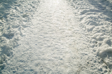 .Winter white snow-covered road close up background