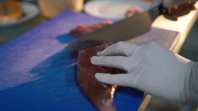 Close up of master chief cutting meat on the kitchen 4K