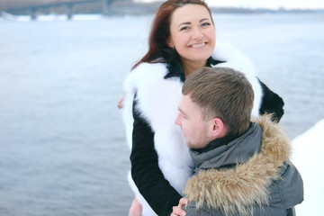 Winter love story. Young couple engagement outdoors.