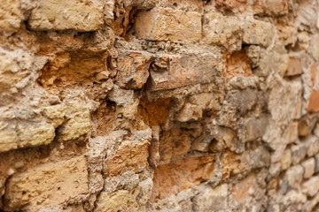 Damaged old wall. Texture of aged bricks. Time is ruthless.