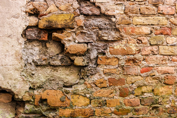Old brick wall. Cracked bricks and cement. Time turns beauty into ruins.