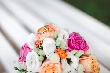 Two Golden Wedding Rings on flowers macro shot