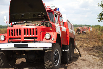 fire truck puts out in a field a forest firefire