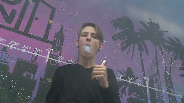 Boy make vape tricks.