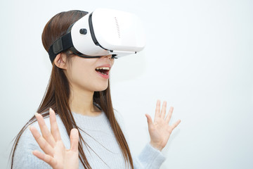 Young attractive Japanese woman using VR-headset glasses