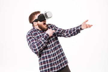 Young Bearded man in shirt using virtual reality device