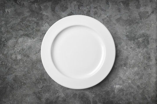 Empty plate on cement background. Top view with clipping path