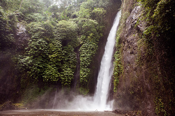 Munduk waterfall in jungle in Bali island, Indonesia