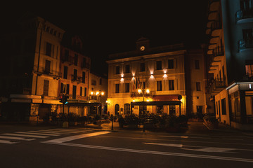 Fototapeta premium Street of town at night. Facade of building with flags. The foreign embassy.