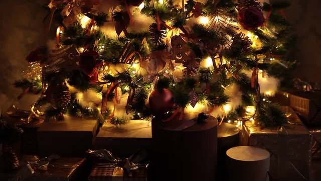 Presents under New Year tree with flashing garland background