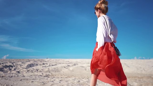 Girl in skirt fluttering in the wind