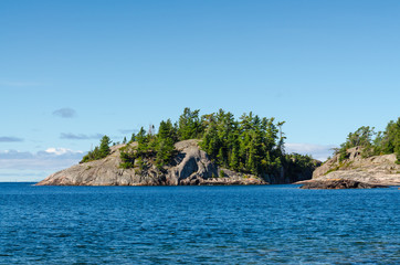 Rocky island with pine trees at the north shore of Lake Superior