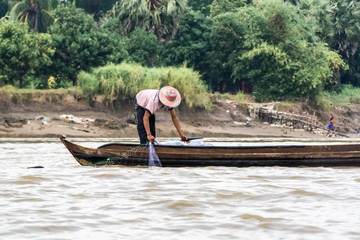 Burmese fisherman netting fish in a river near Yangon, Irrawaddy delta, Myanmar 2
