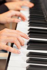 Fototapeta premium Closeup of hands playing piano. Music and hobby concept