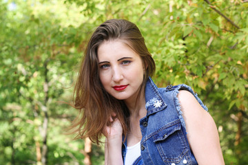 Fototapeta premium Portrait of a charming girl on the grass