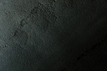 Cracked asphalt, lighted at night - texture background