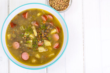 Hot and thick soup with lentils and sausages