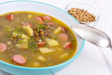Hot and thick soup with lentils and sausages