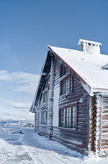 Wooden house in winter in the mountains