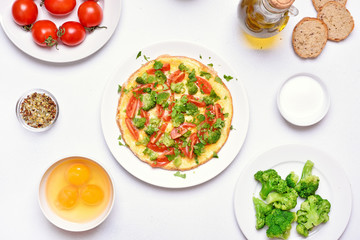 Frittata with eggs, broccoli, tomato, onion, parsley.