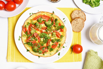 Omelette with broccoli, tomato and green herbs