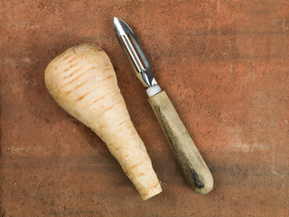 Fresh Uncooked Raw Parsnip With A Vegetable Peeler