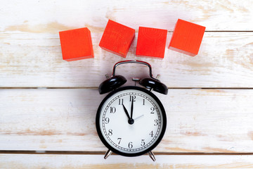 alarm clocks on wooden table