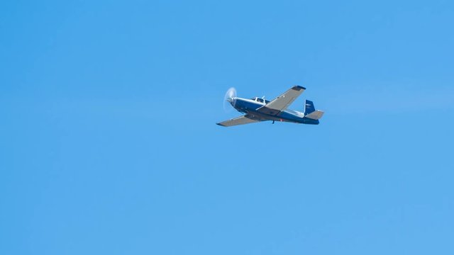 Generic Private Airplane Close-up Flying in Blue Sky Passing White Clouds