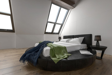 Fototapeta na wymiar Designer modern bedroom with slanted windows