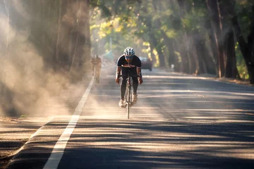 Schilderijen op glas Asian man is cycling on the nature road bike in the morning © arhendrix
