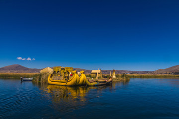 Fototapeta na wymiar Peru, Titicaca lake, Uros Islands (cane islands). Local boat for the tourists made of cane.