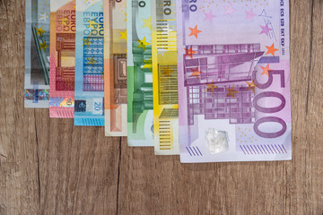 et of euro banknotes on wodden desk.