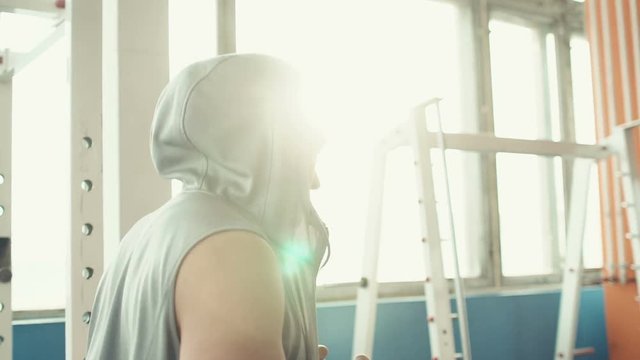Young athletic man doing warm-up before exercise and boxing