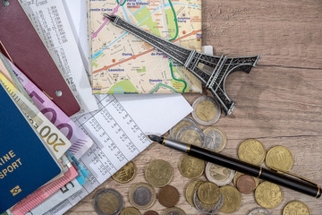 travel concept - eiffel tower, passport, euro money on desk.