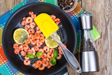 Small shrimp with lemon in a frying pan