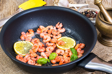 Small shrimp with lemon in a frying pan