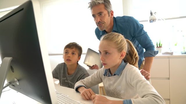 Teacher with school kids in computer laboratory