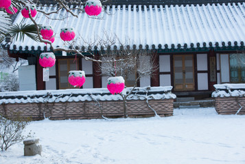 Tiled roof covered with white snow and lotus lantern