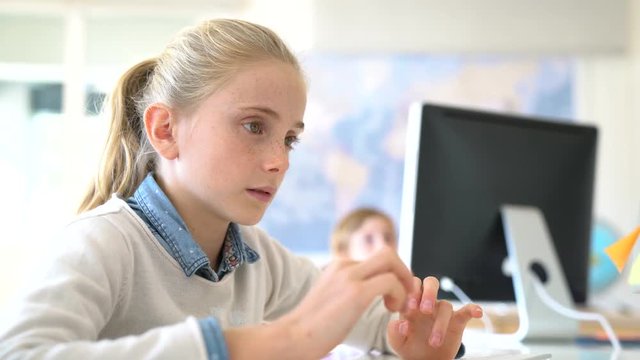 Kids in computer lab working on desktop computer