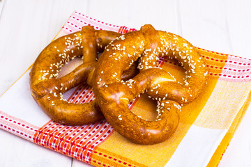Bavarian pretzels with sesame seeds on white boards