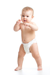 Cute smiling baby learning to walk. Kid weared diaper Isolated on white background.