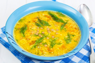Pea soup with vegetables and dill on a white background